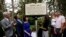 Jon Parrish Peede, chairman of the National Endowment for the Humanities, second from left, joins Gov. Phil Bryant, left, and members of celebrated writer Eudora Welty's family in unveiling the inaugural Mississippi Writers Trail marker, outside Welty's house in Jackson, Miss., Sept. 10, 2018.