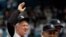 FILE - Whitey Ford waves beside Yogi Berra and Reggie Jackson during a New York Yankees Old Timers Day game introduction at Yankee Stadium in New York, July 7, 2007. 