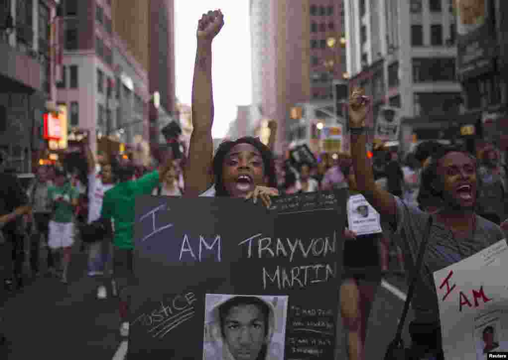 A woman yells slogans as demonstrators demand justice for Trayvon Martin while marching to Times Square from New York's Union Square, July 14, 2013.