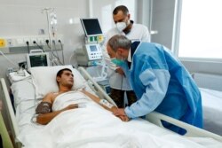FILE - In this photo provided by the Armenian Prime Minister Press Service via PAN Photo, Prime Minister Nikol Pashinyan speaks to a wounded serviceman at a military hospital in Yerevan, Armenia, Oct. 23, 2020.