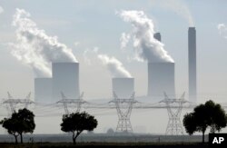 FILE - Steam billows from the chimneys at a heavily polluting and coal-fired Lethabo power station in Vereeniging, South Africa, on Dec. 5, 2018.