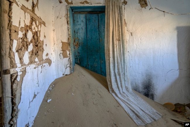 A house decimated by sandstorms sits in the destroyed village on the edge of the dried-up Aral Sea, near Tastubek, Kazakhstan, Monday, July 3, 2023. (AP Photo/Ebrahim Noroozi)