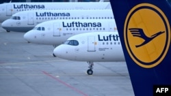 FILE - The logo of German airline Lufthansa can be seen on the vertical stabilizer of a plane standing with other aircraft at the airport in Frankfurt, Germany, on March 7, 2024. The airline announced on Aug. 1, 2024, that it is canceling flights to and from Israel until Aug. 8.