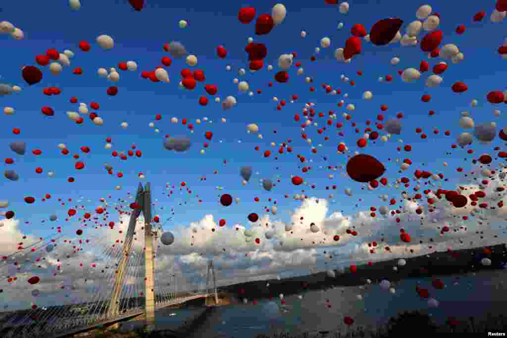 Red and white balloons are released during the opening ceremony of the newly built Yavuz Sultan Selim bridge, the third bridge over the Bosphorus linking the city&#39;s European and Asian sides in Istanbul, Turkey.