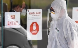 A medical worker enters the Epping Gardens aged care facility in the Melbourne suburb of Epping on July 30, 2020, as the city battles fresh outbreaks of the COVID-19 coronavirus.