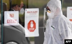 A medical worker enters the Epping Gardens aged care facility in the Melbourne suburb of Epping on July 30, 2020, as the city battles fresh outbreaks of the COVID-19 coronavirus.