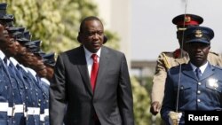 Kenya's President Uhuru Kenyatta inspects a guard of honor before the annual State of the Nation address at the Parliament Buildings in Nairobi, March 31, 2016. 