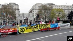 The road is blocked by demonstrators during a climate protest at Marble Arch in London, Tuesday, April 16, 2019. 