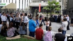 People gather outside a building that was temporarily evacuated in Sao Paulo, Brazil, April 2, 2018, after a powerful 6.8-magnitude earthquake struck Bolivia. 