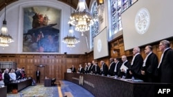 Handout picture released by the Colombian Foreign Ministry showing representatives of Colombia (L) and judges of the International Court of Justice (ICJ) standing before the UN's top court gives its verdict in the latest legal battle between Colombia and 