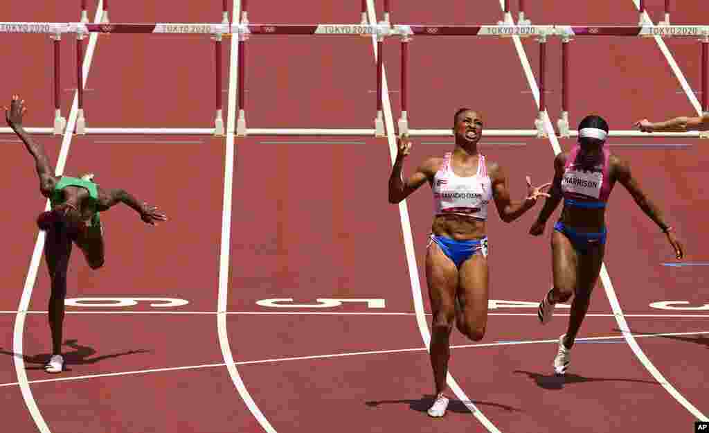 Jasmine Camacho-Quinn, of Puerto Rico, center, celebrates after winning the gold in the women&#39;s 100-meters hurdles final ahead of Kendra Harrison, of United States, silver, right, and Tobi Amusan, of Nigeria, fourth, at the 2020 Summer Olympics, Monday, Aug. 2, 2021, in Tokyo, Japan. (AP Photo/Charlie Riedel)