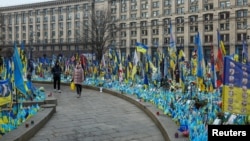 People visit a makeshift memorial for fallen Ukrainian soldiers at the Independence Square in Kyiv, Ukraine, Feb. 14, 2025. 