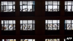 FILE - This photo taken on May 17, 2023 shows high school students going through exam papers, ahead of the National College Entrance Examination, known as “gaokao”, in Handan, in China's northern Hebei province.