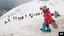 FILE - Downhill skiers are on a slope as Alpine ski season opens at the newly built Rosa Khutor ski resort in Krasnaya Polyana near the Black Sea resort of Sochi, southern Russia. 