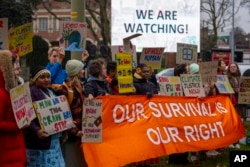 Activists protest outside the International Court of Justice in The Hague, Netherlands, as it opens hearings into what countries worldwide are legally required to do to combat climate change and help vulnerable nations fight its impact, Dec. 2, 2024.