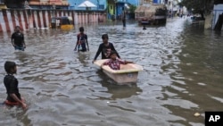 A boy pushes another in a bathtub in a waterlogged street in Chennai, India, Nov. 3, 2017. Incessant rainfall caused flooding and traffic jams in several parts of the southern Indian city Friday.