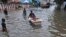 A boy pushes another in a bathtub in a waterlogged street in Chennai, India, Nov. 3, 2017. Incessant rainfall caused flooding and traffic jams in several parts of the southern Indian city Friday.
