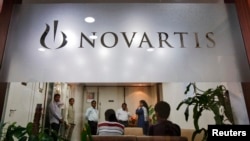 People gather at Novartis India headquarters in Mumbai April 1, 2013.