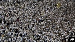 Muslim pilgrims circle the Kaaba and try to touch Maqam Ibrahim or The Station of Abraham, the golden glass structure top right, at the Grand Mosque in the Muslim holy city of Mecca, Saudi Arabia, Wednesday, Sept. 7, 2016. 