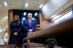 President Donald Trump and first lady Melania Trump observe a moment of silence on Air Force One as he arrives at the airport in Johnstown, Pa., on his way to speak at the Flight 93 National Memorial, Sept. 11, 2020, in Shanksville, Pa.