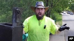 In this still image from video, Magnet fisher James Kane exclaims as he reacts to the contents of a safe he pulled out of a pond, in Flushing Meadows Corona Park, in the Queens borough of New York, Friday May 31, 2024. (James Kane and BarbI Agostini @LetsGetMagnetic via AP)