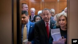House Democrats crowd into an elevator as they rush to the chamber for a vote just after meeting with Speaker of the House Nancy Pelosi, who is moving swiftly toward House passage of a coronavirus aid package, on Capitol Hill, March 11, 2020. 