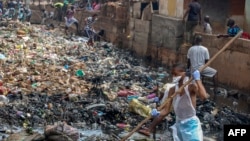 FILE - Residents of Freetown take part in "National Cleaning Day" on May 5, 2018. The first Saturday of each month, citizens of Sierra Leone are called to clean their streets.