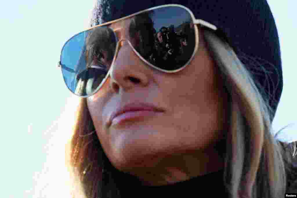 U.S. President Donald Trump is reflected in first lady Melania Trump&#39;s sunglasses as he speaks to the media, as they arrive to assess recovery efforts and tour areas devastated by Hurricane Helene, in Asheville, North Carolina.