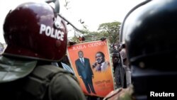 Riot policemen stand guard as supporters of Kenyan opposition National Super Alliance (NASA) coalition protest in Nairobi, Kenya, Oct. 11, 2017. 