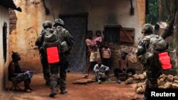 French soldiers conduct a daytime patrol in a Bangui neighborhood after shooting continued overnight in the capital, in Central African Republic, Dec. 26, 2013.