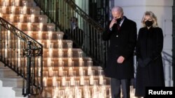 U.S. President Joe Biden and his wife Jill Biden attend a candle-lighting ceremony to commemorate the grim milestone of 00,000 U.S. deaths from COVID-19, at the White House, Feb. 22, 2021.
