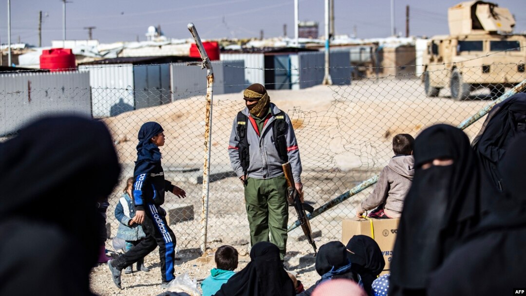 FILE - A member of Kurdish internal security stands guard at the Kurdish-run al-Hol camp, in northeastern Syria, Jan. 28, 2021.