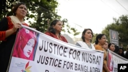 FILE - Protesters demand justice for an 18-year-old Nusrat Jahan Rafi who was killed after she was set on fire for refusing to drop sexual harassment charges against her Islamic school's principal, in Dhaka, Bangladesh, April 19, 2019.