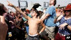 Flash mob participants imitate dance steps of Rolling Stones singer Mick Jagger, Glastonbury Music Festival at Worthy Farm, Somerset, England, June 26, 2013.