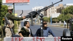 A Houthi fighter mans a machine gun on an army patrol truck while securing a road where people demonstrated against the Saudi-led airstrikes in Yemen's capital Sana'a, Oct. 18, 2015.