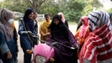 Humaira Rafaqat teaches women how to ride a bike while wearing an abaya, during a training session as part of the "Women on Wheels" program organized by the traffic police department in Lahore, Pakistan, October 1, 2024. (REUTERS/Nida Mehboob)