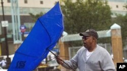 A commuter struggles with his umbrella during heavy rain in the Bronx borough of New York City, 01 Oct 2010