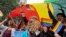 Participants displays a rainbow flag and cheer as gay rights activists and their supporters march during a gay pride parade in New Delhi, India, Nov. 12, 2017.