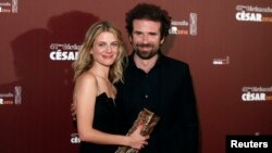 Directors Melanie Laurent and Cyril Dion hold their trophy after receiving the Best Documentary Feature Award for their film "Tomorrow" at the 41st Cesar Awards in Paris, Feb. 26, 2016. 