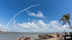 Des curieux assistent au décollage de la fusée spatiale Ariane 5 emportant quatre satellites Galileo du port spatial européen de l'ESA à Kourou, en Guyane française, le 17 novembre 2016.