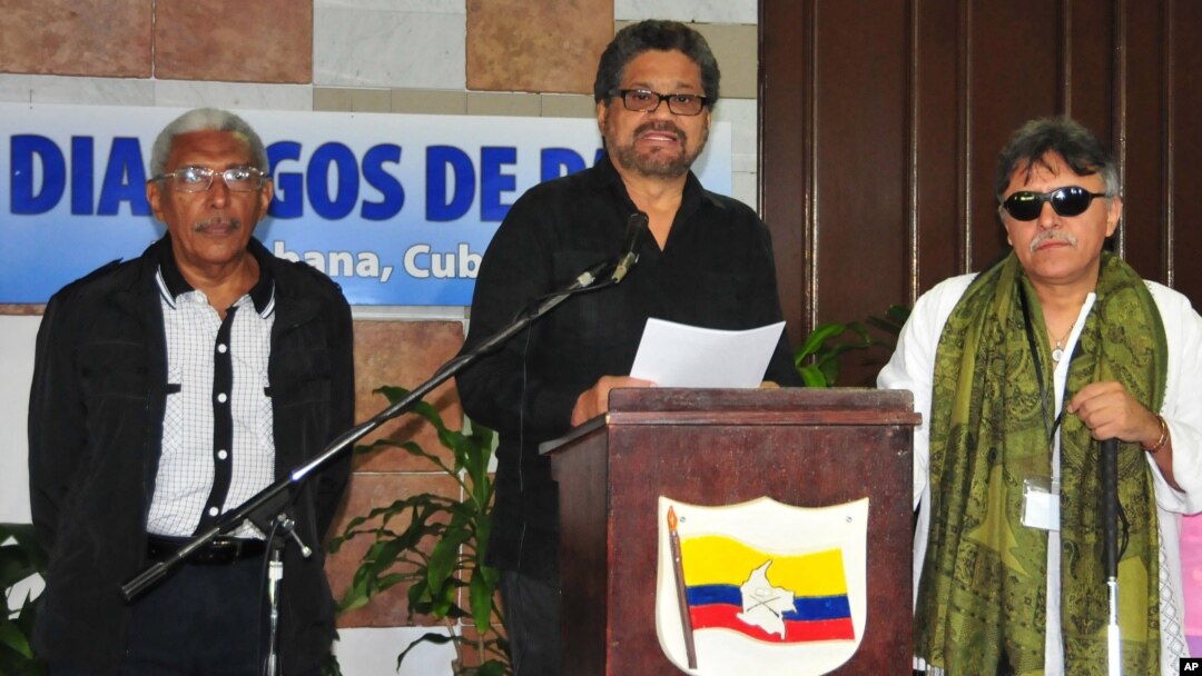 FILE - Ivan Marquez, chief FARC negotiator, with Central Staff member Jesus Santrich, right, and rebel commander Joaquin Gomez, left, speaks at a news conference at the close of a round of peace talks with Colombia's government in Havana, Feb 12, 2015.