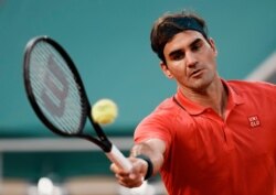 Switzerland's Roger Federer returns a shot to Germany's Dominik Koepfer during their match on day seven of the French Open tennis tournament at Roland Garros in Paris, France, June 5, 2021.