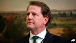 FILE - White House counsel Don McGahn waits for the arrival of President Donald Trump in the Roosevelt Room of the White House, May 24, 2018, in Washington.