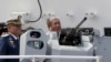 FILE - Philippine Transportation Secretary Arthur Tugade inspects the prototype of the 50-caliber Remote Controlled Weapons System mounted on the new Philippine Coast Guard multi-purpose vessel, Oct. 10, 2019.