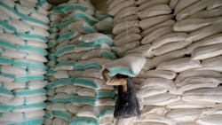 A worker carries a sack of wheat flour at a World Food Program food aid distribution center in Sanaa, Yemen, February 11, 2020. (Khaled Abdullah/Reuters)