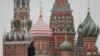 A security specialist stands guard near the Spasskaya tower of the Kremlin and St. Basil’s Cathedral in central Moscow, Feb. 13, 2025.