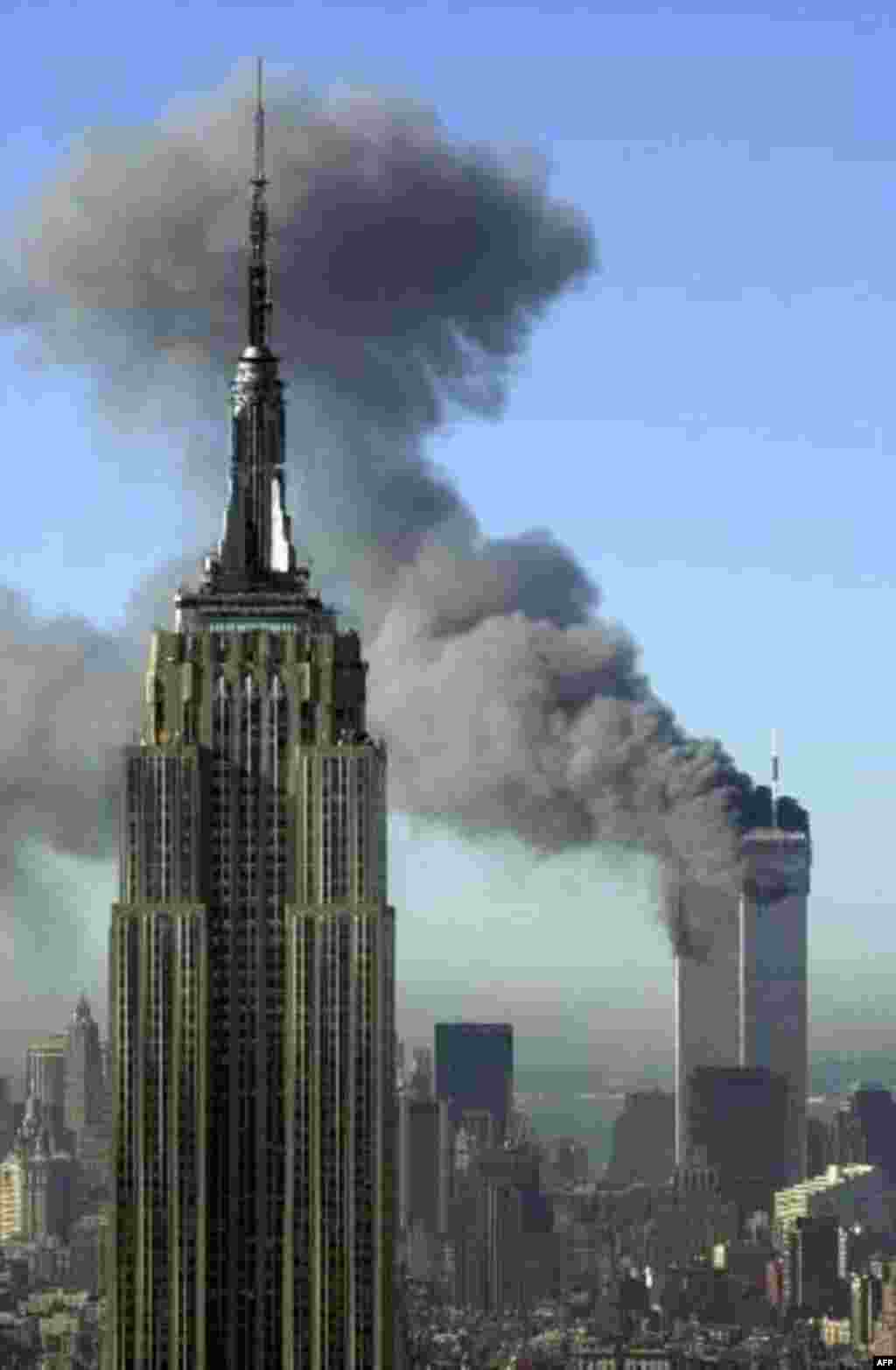 Plumes of smoke pour from the World Trade Center buildings in New York Tuesday, Sept. 11, 2001. Planes crashed into the upper floors of both World Trade Center towers minutes apart Tuesday in a horrific scene of explosions and fires that lead to the colla