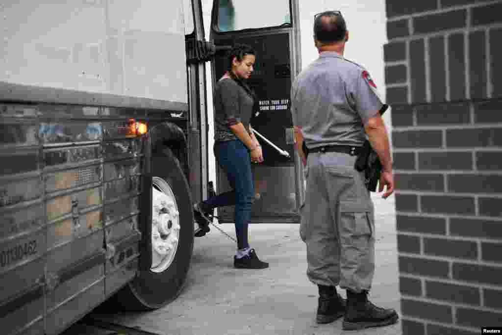 A migrant woman in federal custody arrives for an immigration hearing at the U.S. federal courthouse in McAllen, Texas.