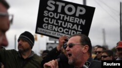 A protester shouts into a microphone during a White Lives Matter rally in Shelbyville, Tenn., Oct. 28, 2017.