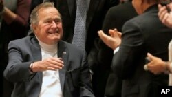 FILE - Former president George H.W. Bush acknowledges the crowd at his presidential library in College Station, Texas, Nov. 11, 2014.